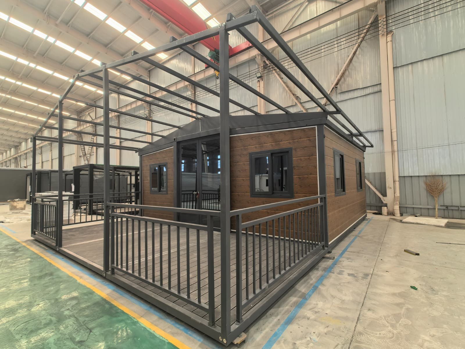 Opposite front angle of a timber-look expandable home at the factory viewing stage