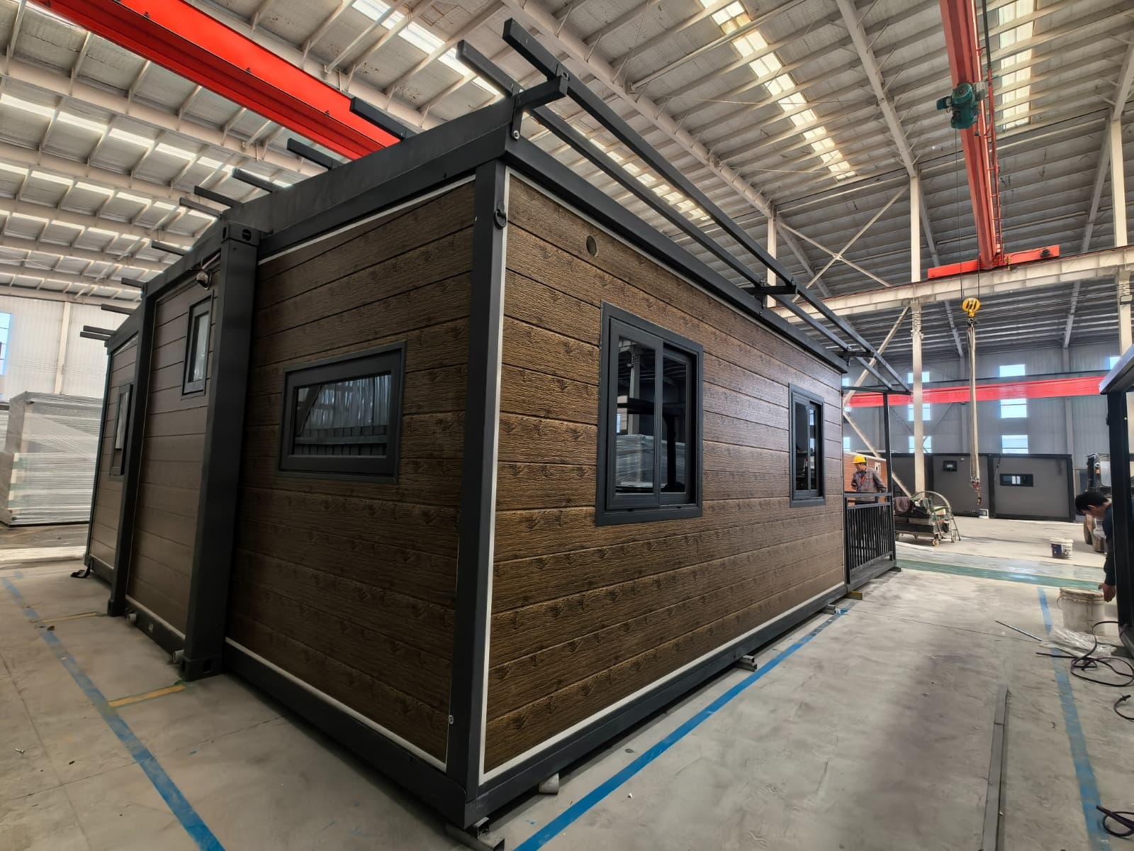 Close exterior view of timber-look cladding and dark-framed windows on an expandable home
